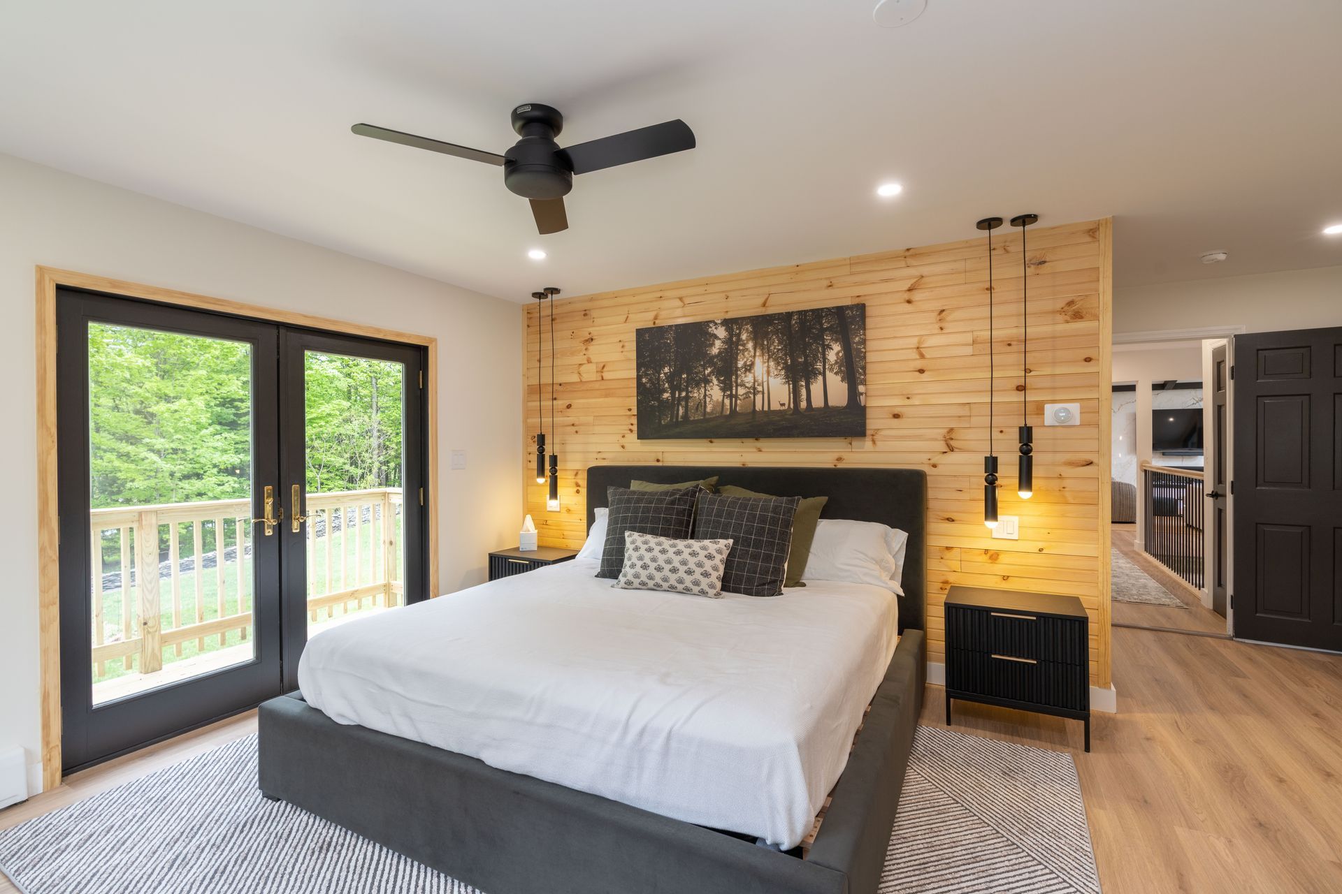 A bedroom with a large bed and a ceiling fan.