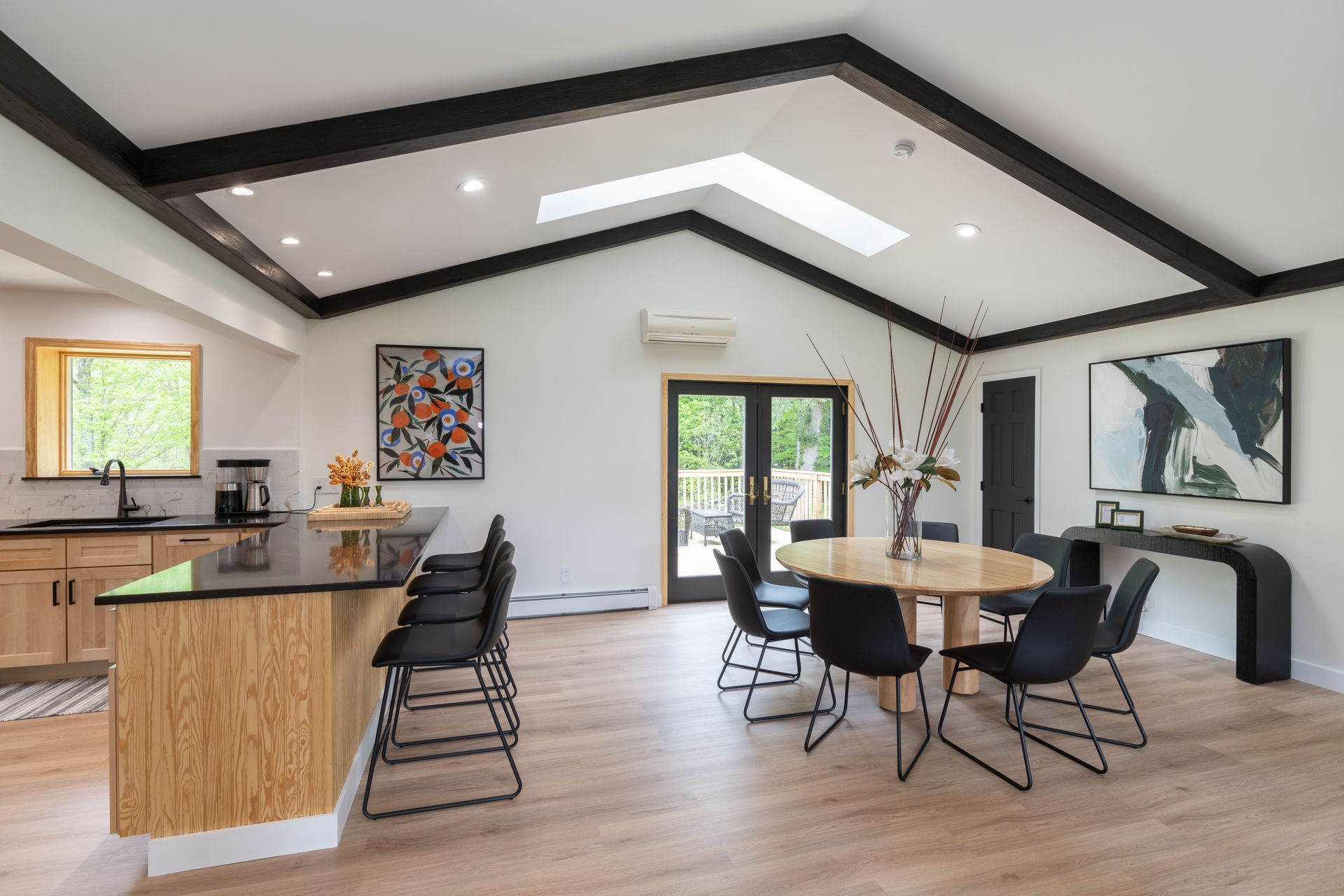 There is a table and chairs in the middle of the room.