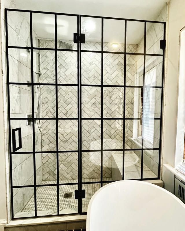 A bathroom with a walk in shower and a bathtub.