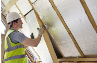 Worker installing insulation on new house in Cheyenne, WY