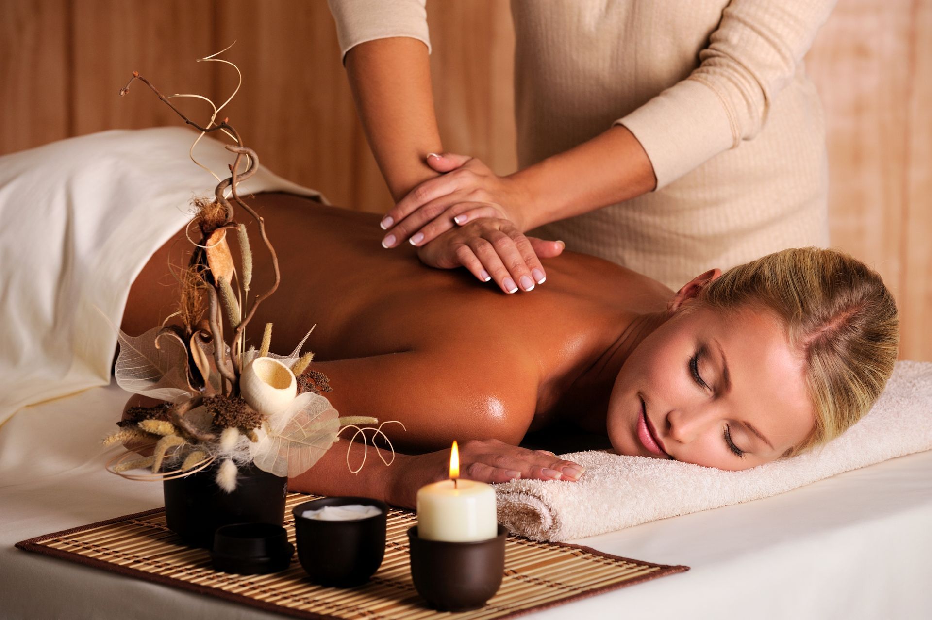 A man is getting a massage from a woman in a spa.