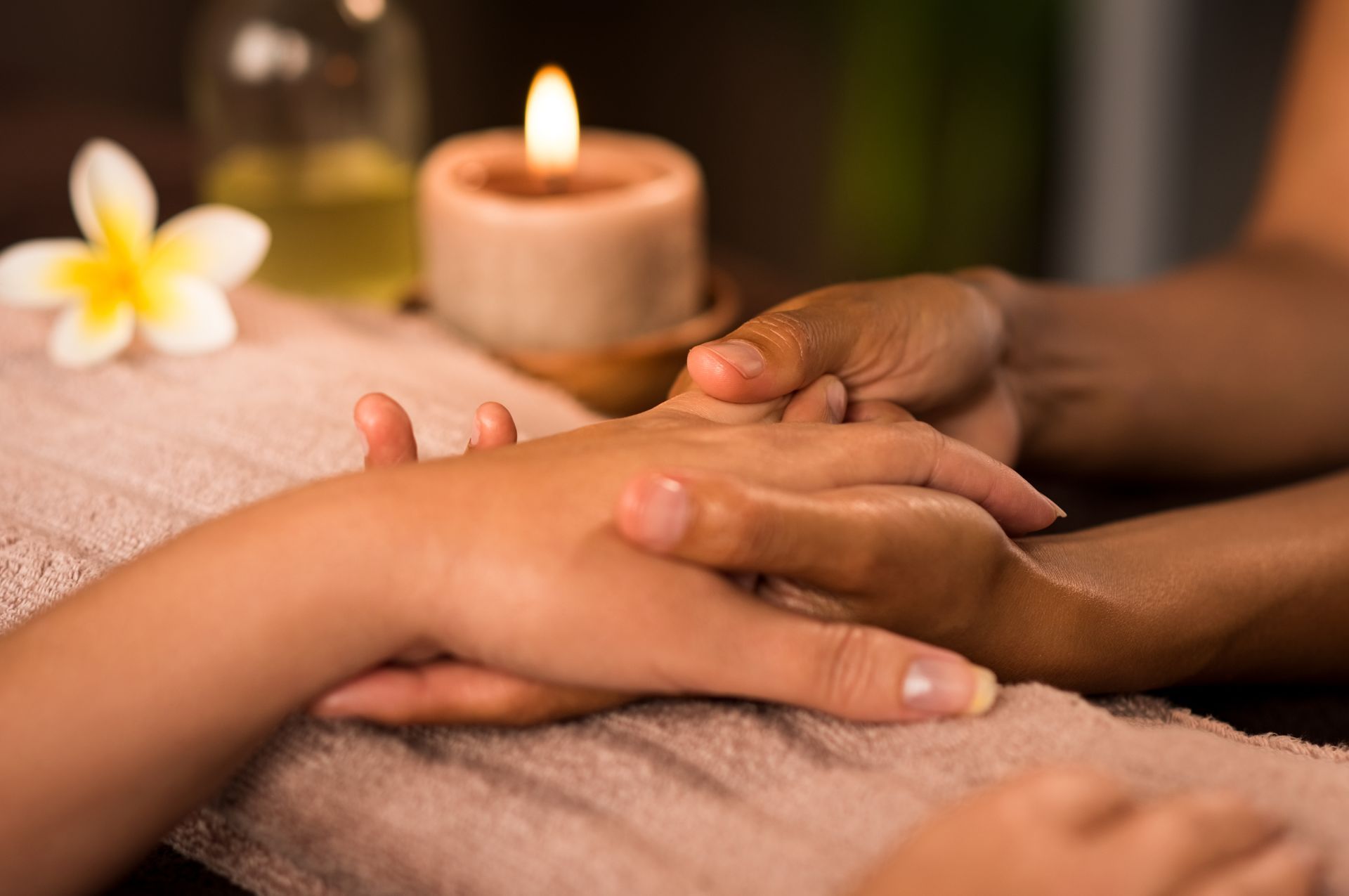 A woman is getting a hand massage at a spa.