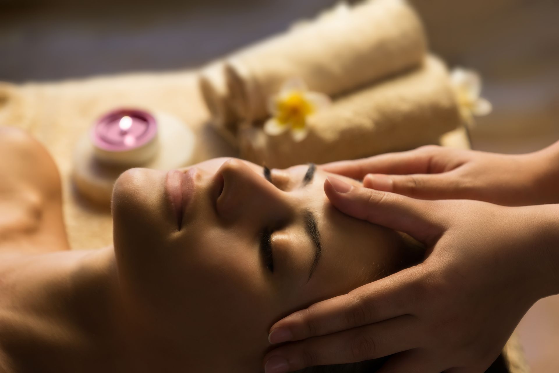 A woman is getting a hand massage at a spa.