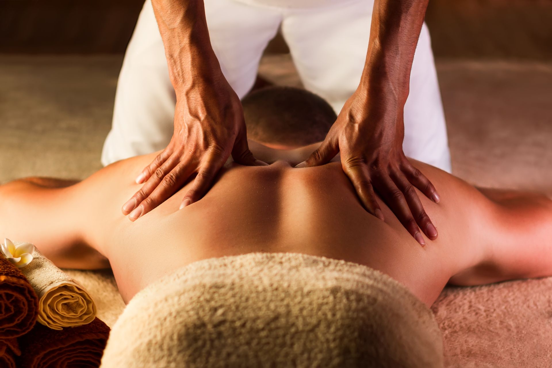 A woman is getting a massage on her leg in a spa.