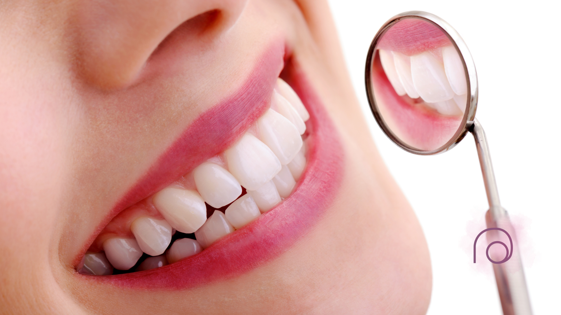 Close-up of a person's smile with white teeth, pink lips, and a dental mirror.