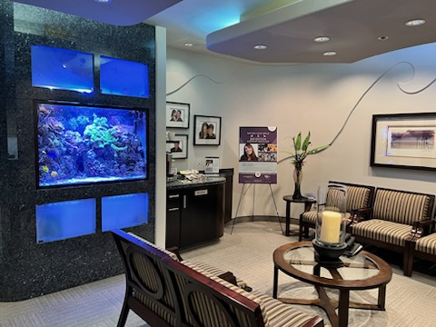 A living room with a fish tank on the wall