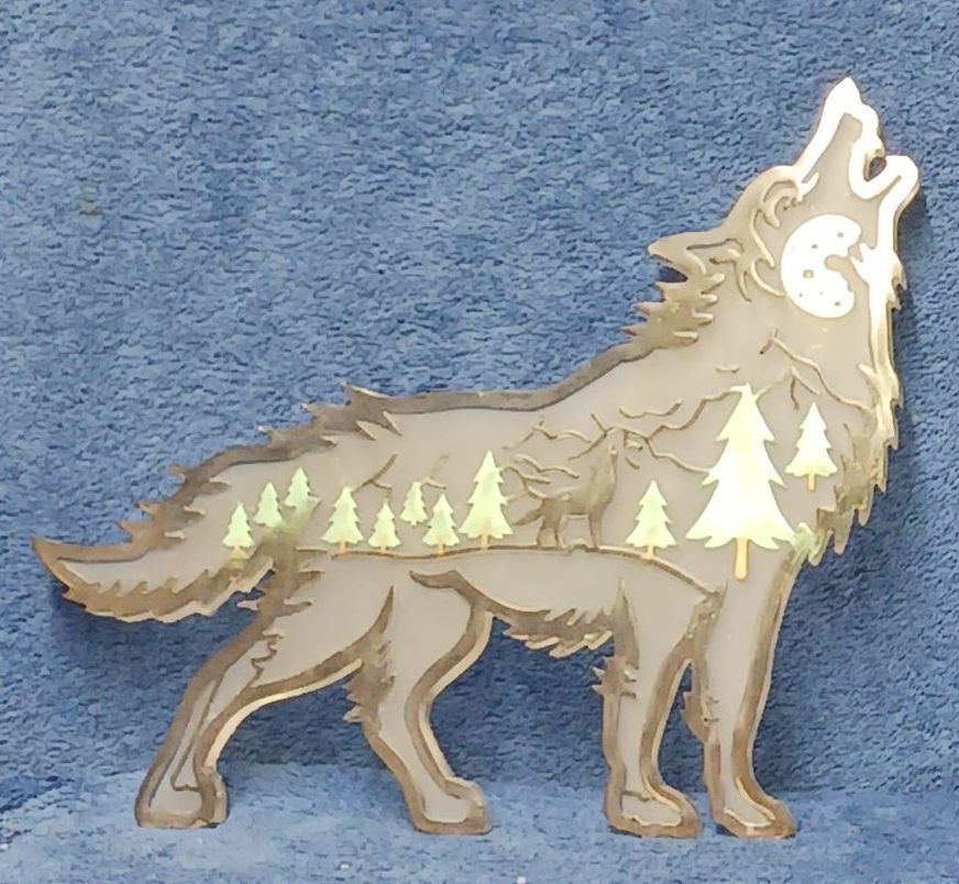 A wooden wolf howling with trees in the background