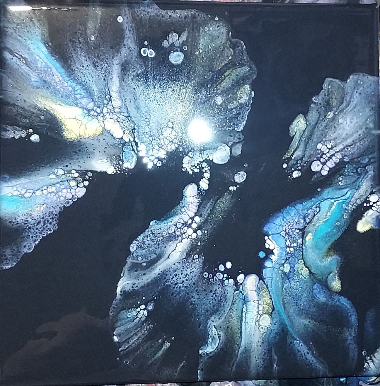 A close up of a painting on a black background