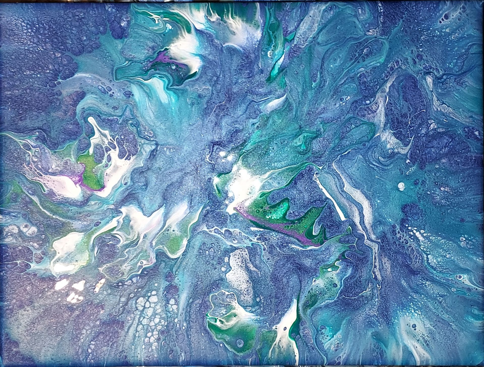 A close up of a blue and purple painting on a canvas.