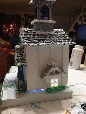 A model of a church is sitting on top of a table.