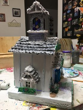 A model of a church is sitting on top of a table.