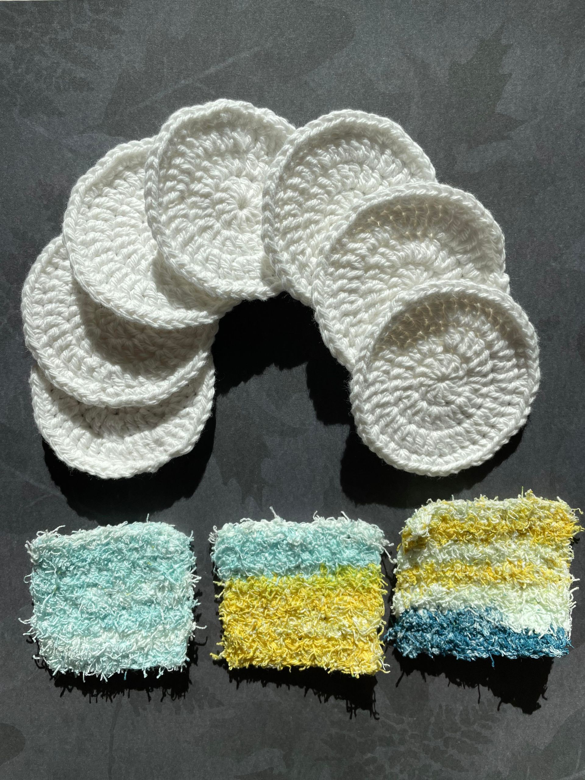 A bunch of crocheted coasters are sitting on a table