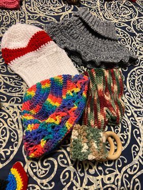 A bunch of crocheted items are sitting on a table.