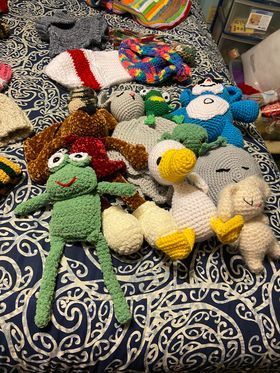 A bunch of stuffed animals are sitting on top of a bed.