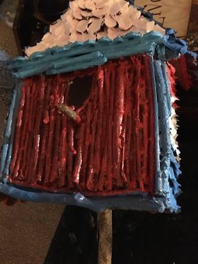 A red white and blue birdhouse