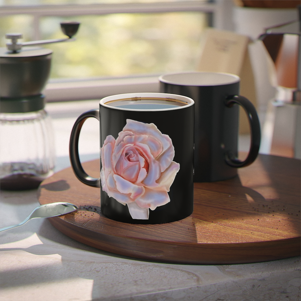 A black coffee mug with a pink rose on it