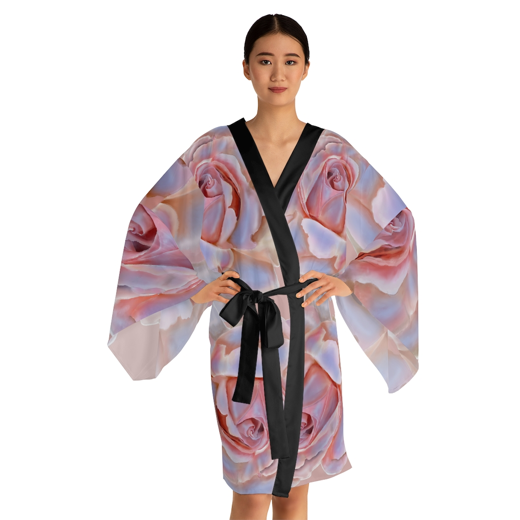 A woman is wearing a robe with pink roses on it