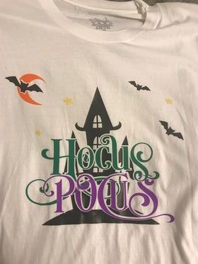 A white t-shirt with the words hocus pocus on it
