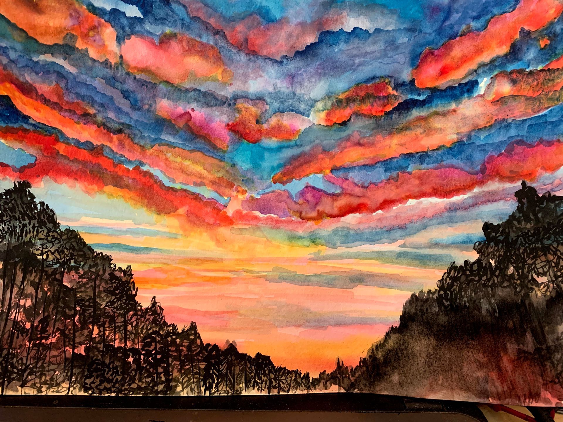A watercolor painting of a sunset over a mountain range with trees in the foreground.