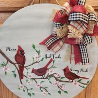 Two cardinals are sitting on a tree branch with flowers.