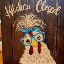A door sign with a cartoon chicken wearing glasses and a blue bow.