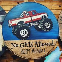 A wooden sign with a monster truck on it that says `` no girls allowed except momma ''.
