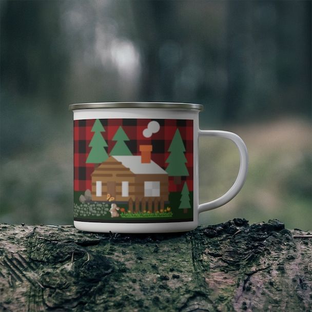 A mug with a cabin and trees on it
