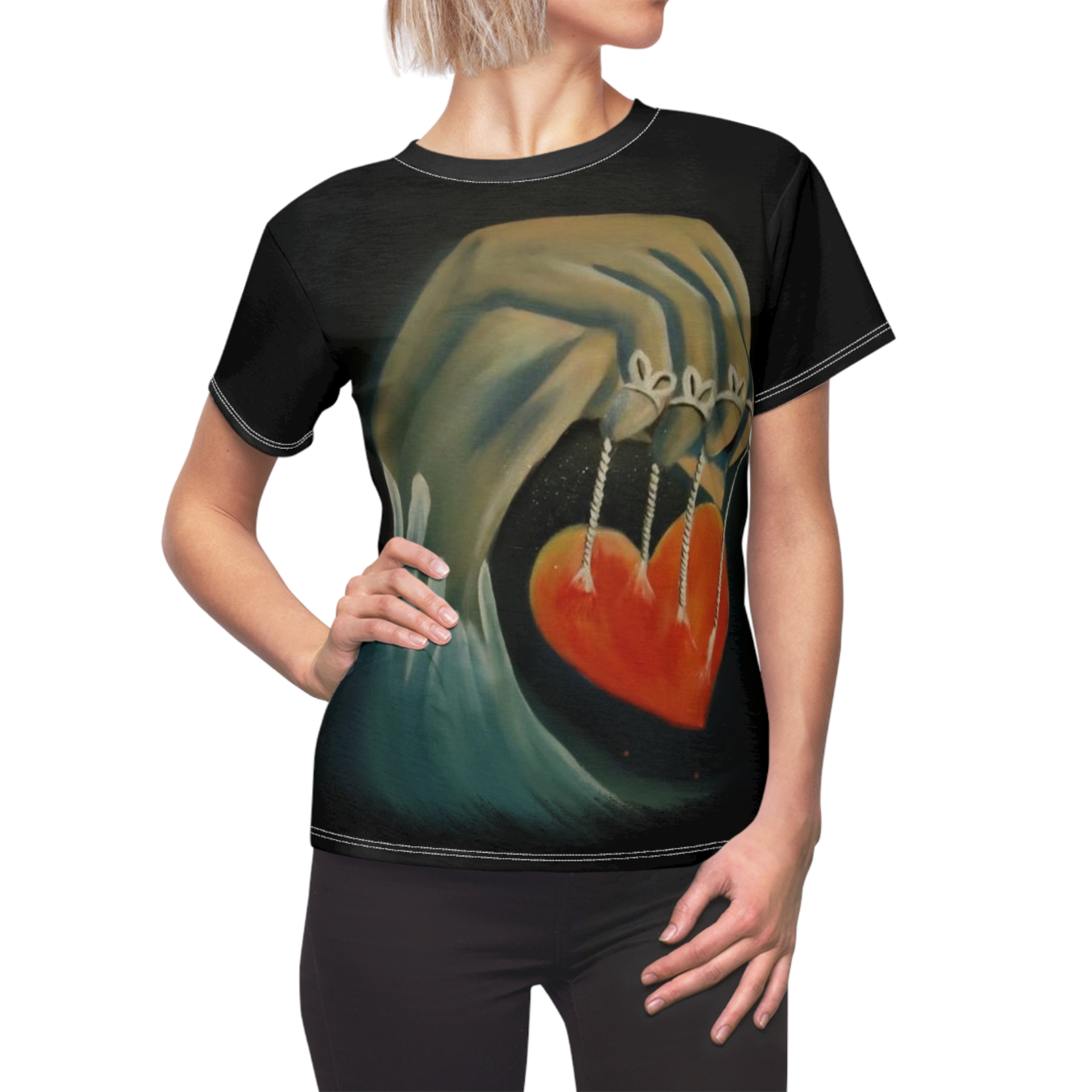 A woman wearing a black t-shirt with a painting of a hand holding a heart