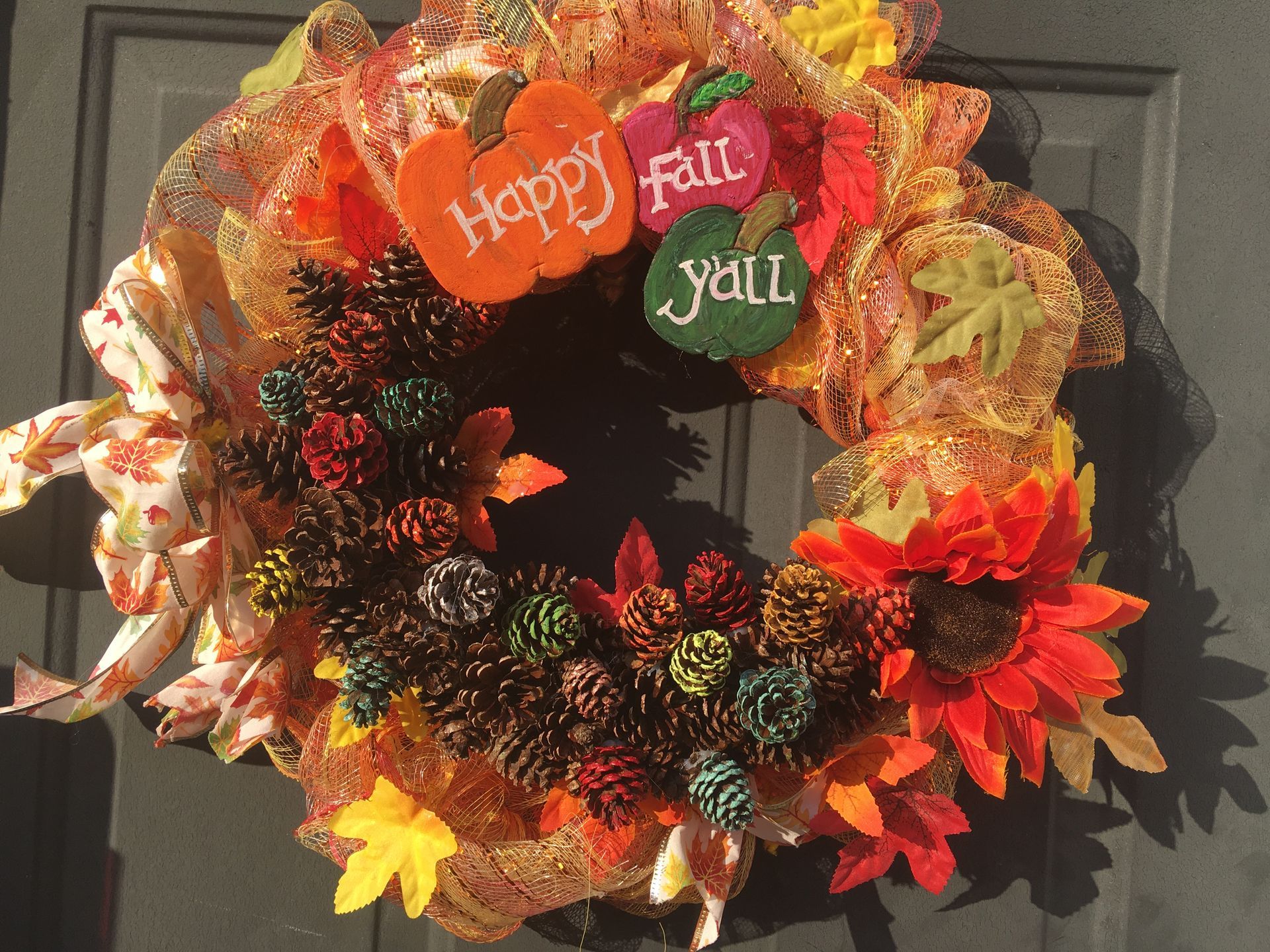 A wreath that says happy fall y'all on it
