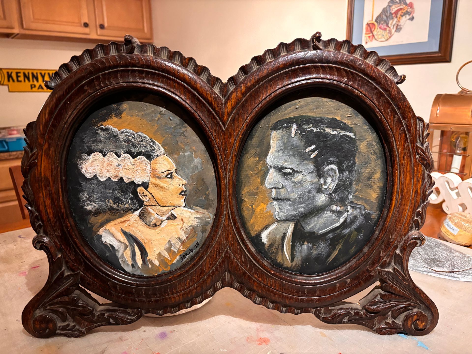A painting of a bride and groom in a wooden frame