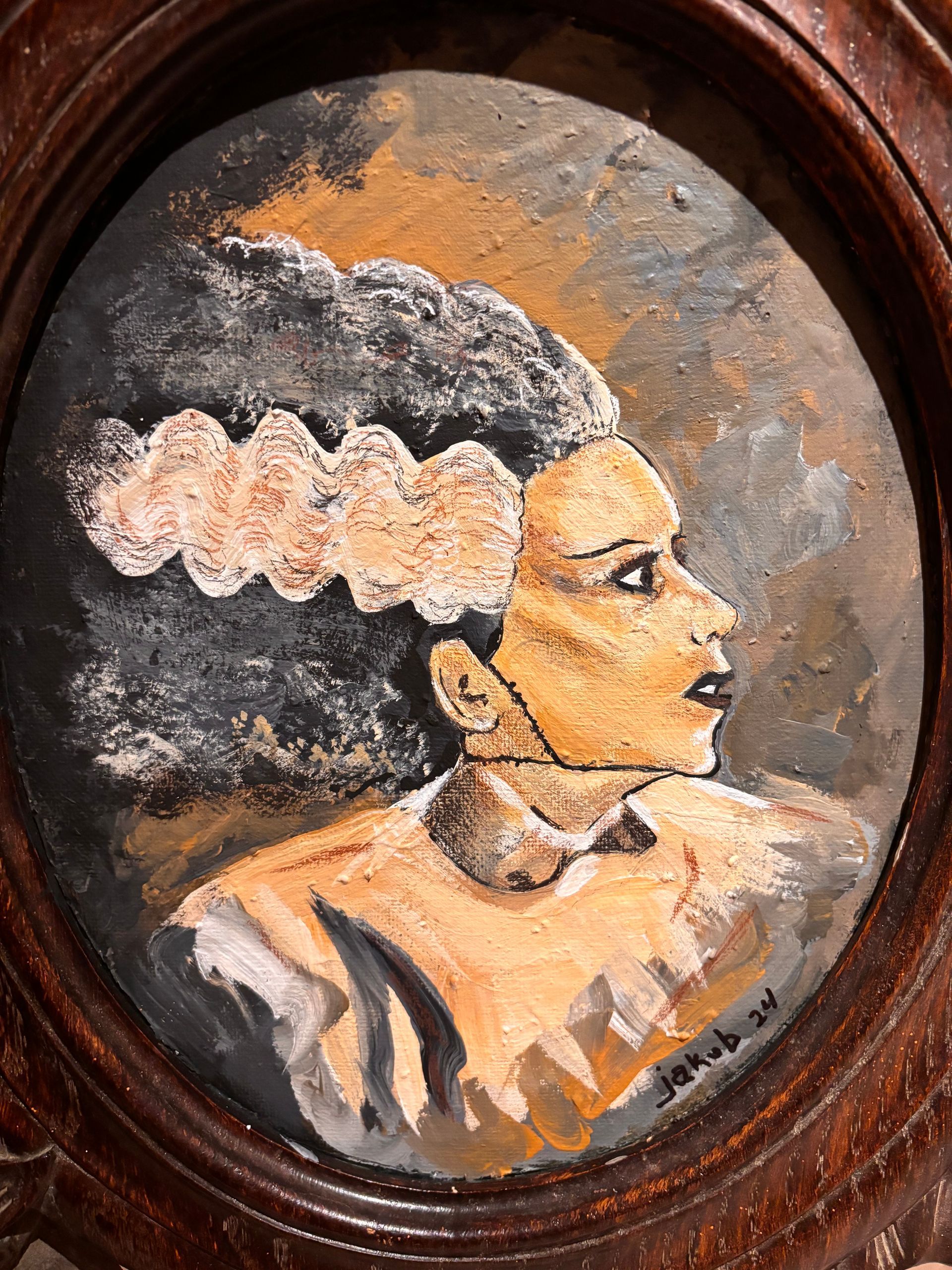 A painting of a bride in a wooden frame