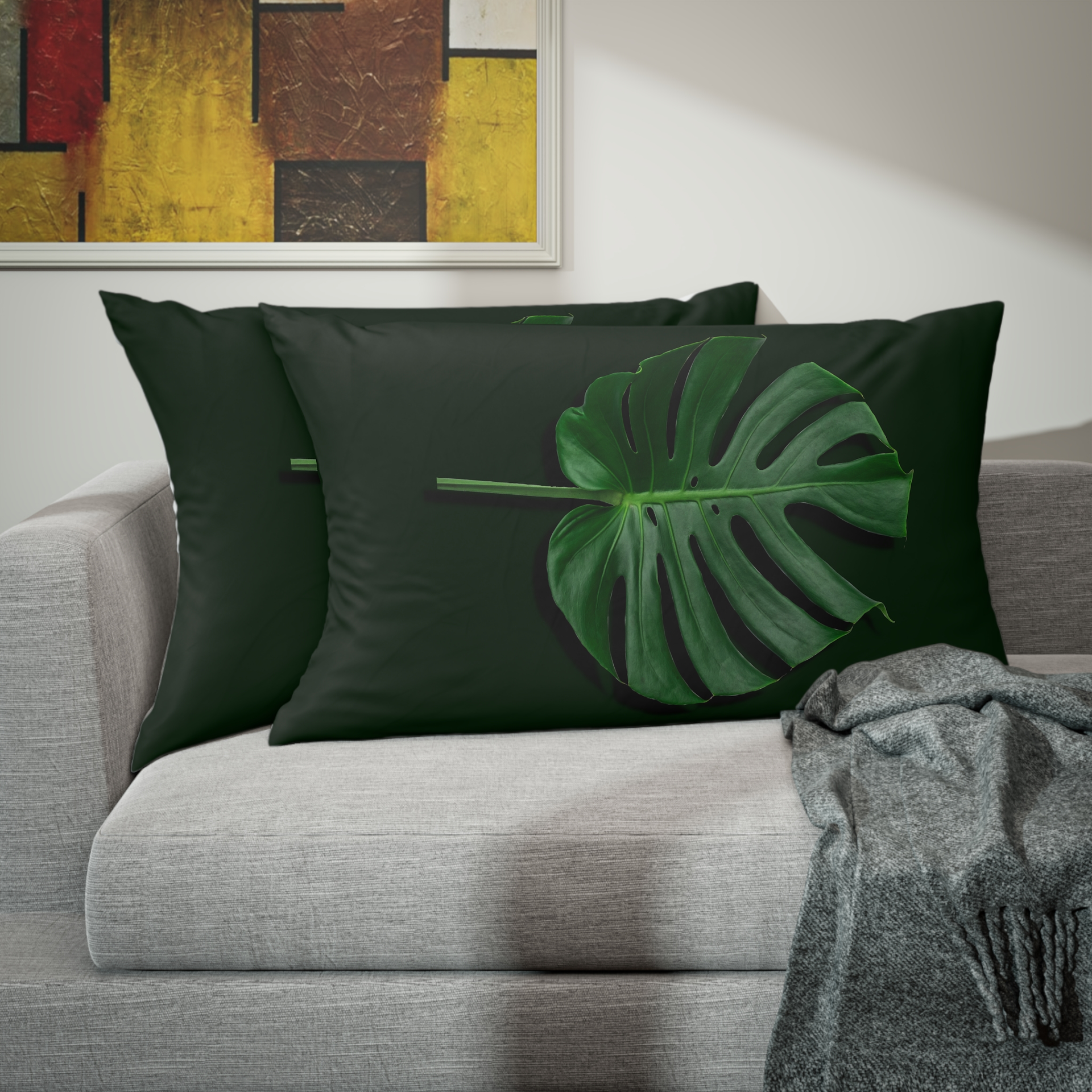 A couch with two pillows and a blanket on it