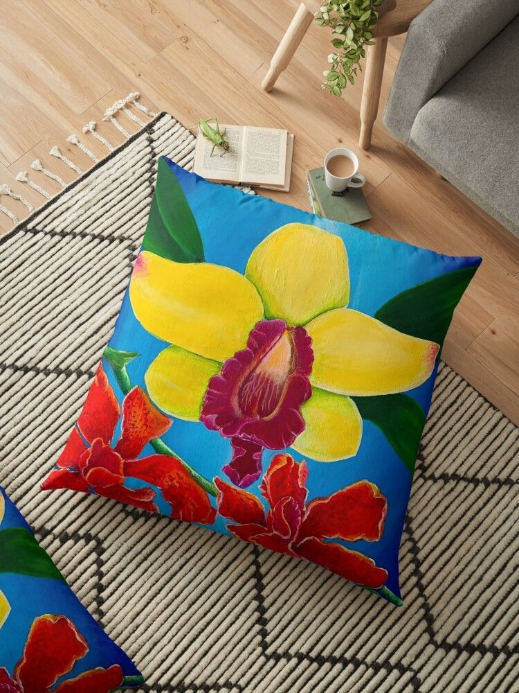 A floor pillow with a yellow flower on it