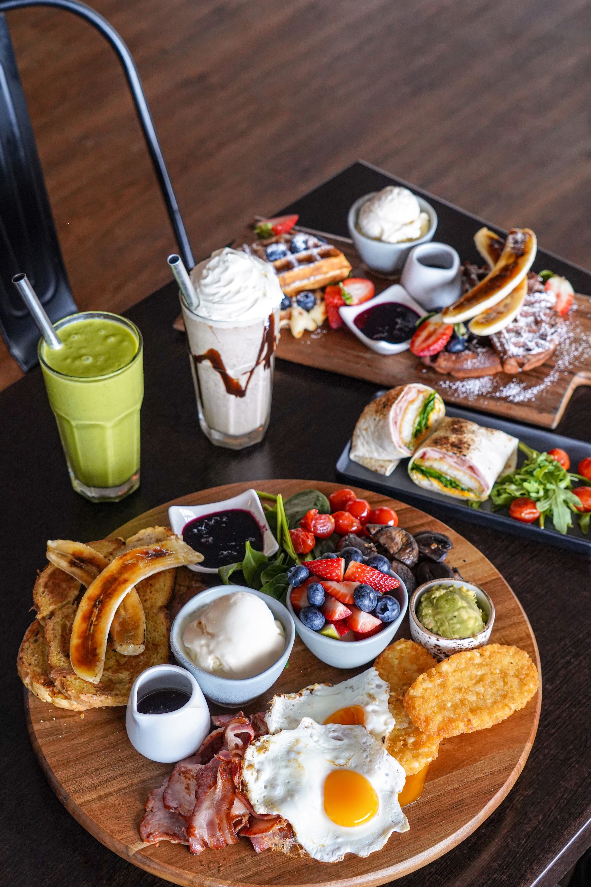 A Table Topped With Plates of Food and Drinks — Café and Restaurant in Whitsundays, QLD