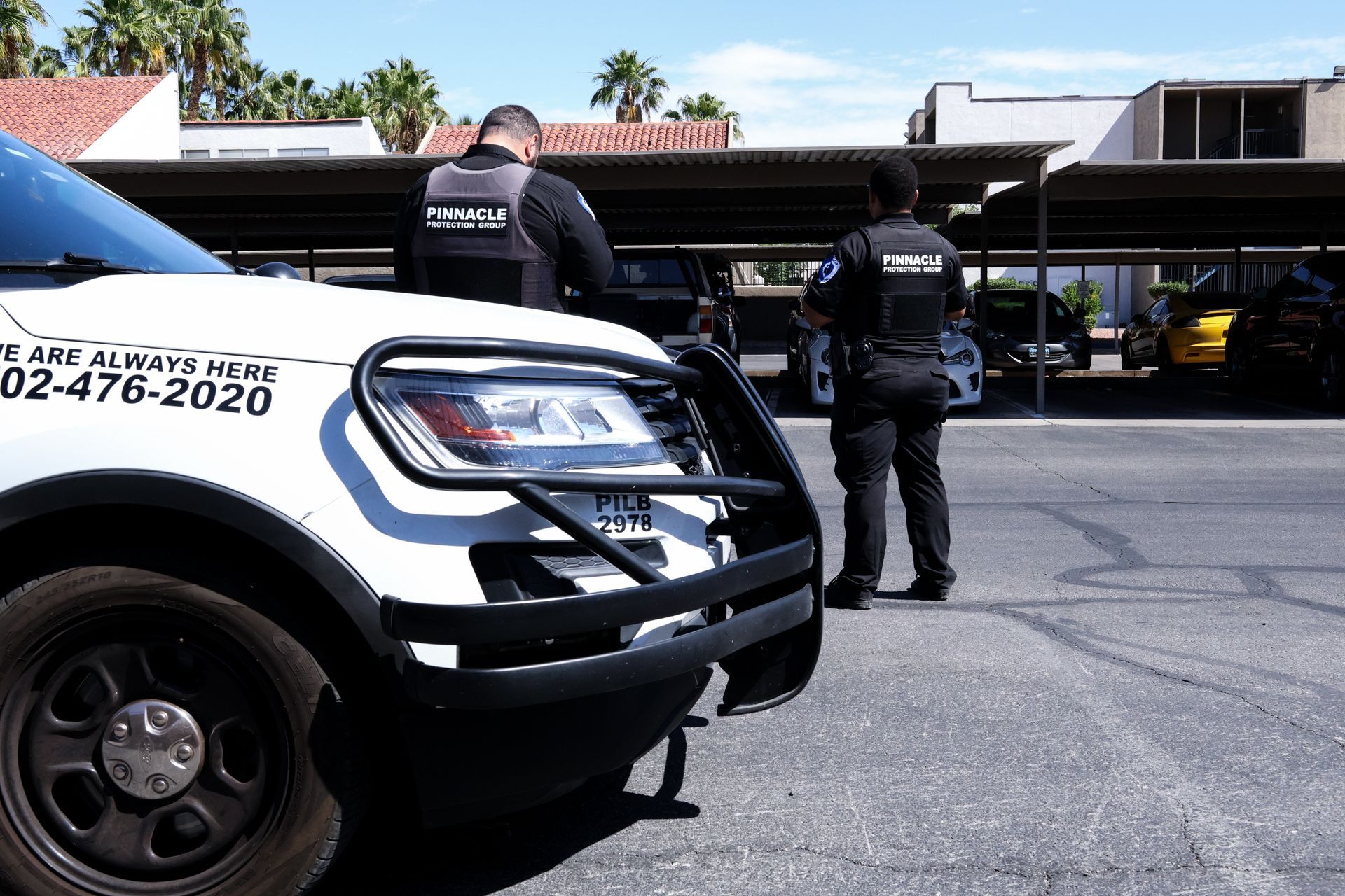 a security car is parked in a parking lot at night .