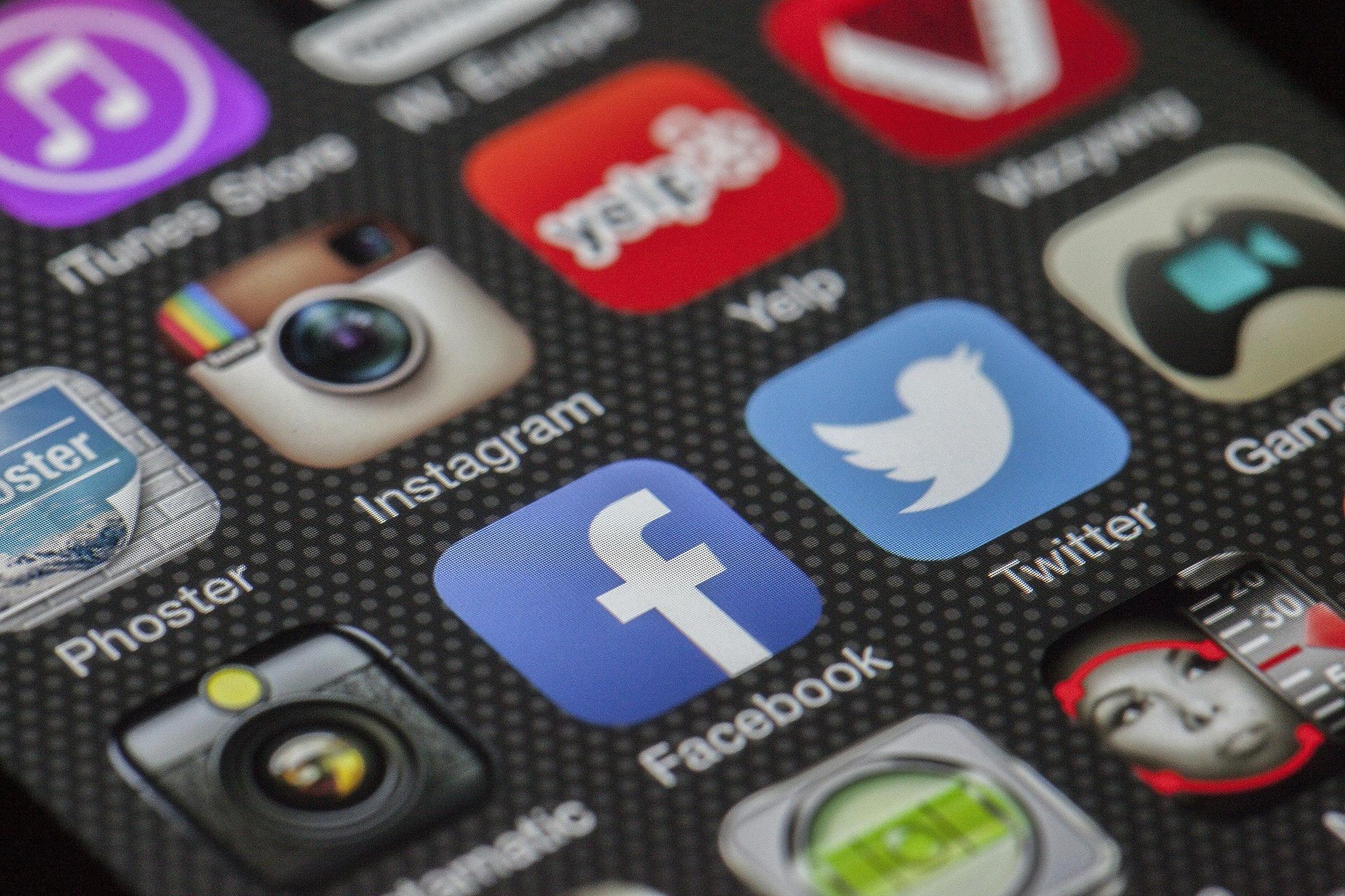 Close-up of a smartphone screen displaying various social media and app icons: Facebook, Instagram, Twitter, etc.