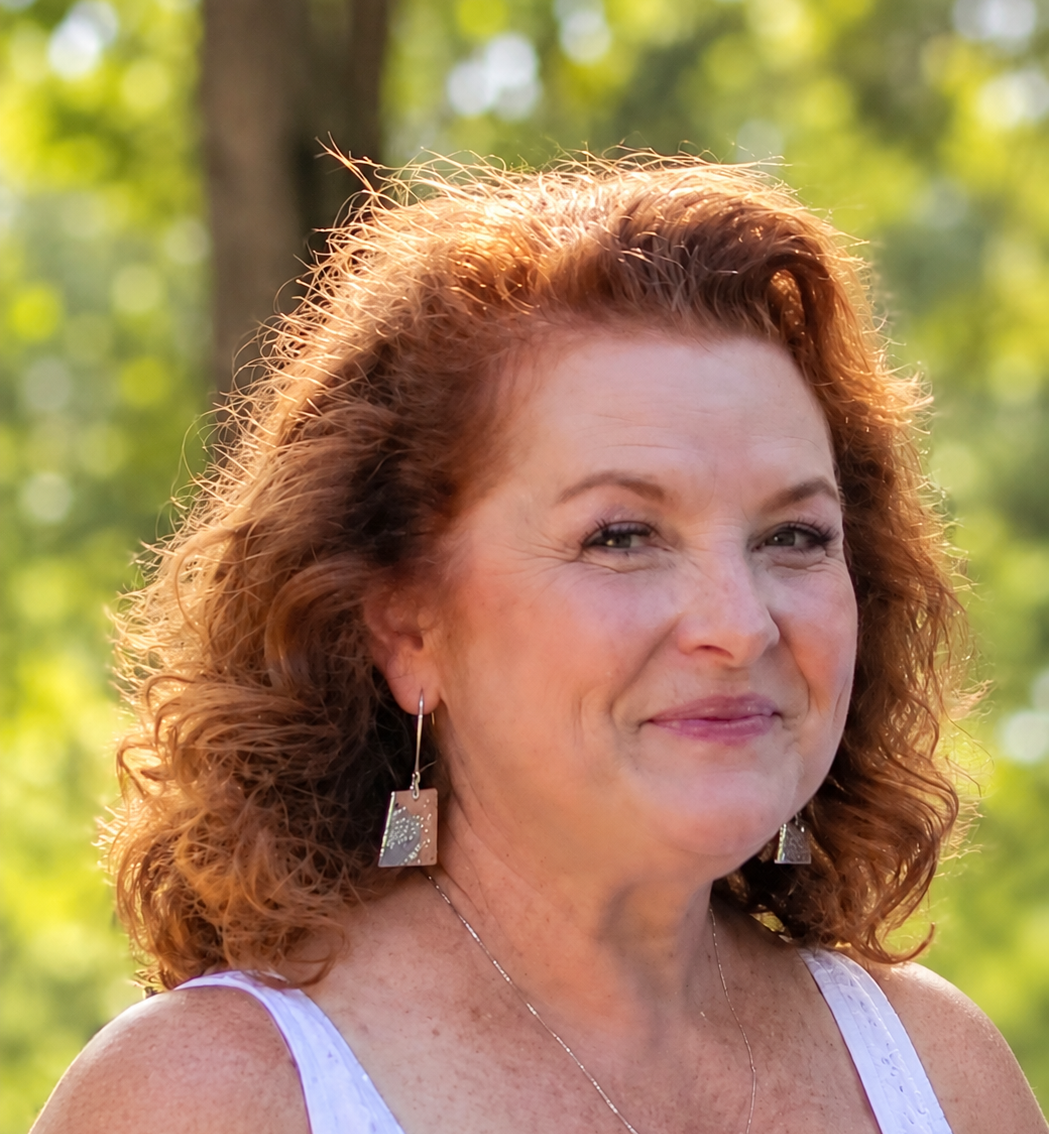 Agency co-founder Sheri Conley smiles on an outdoor balcony.