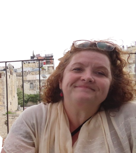 Agency co-founder Sheri Conley smiles on an outdoor balcony.