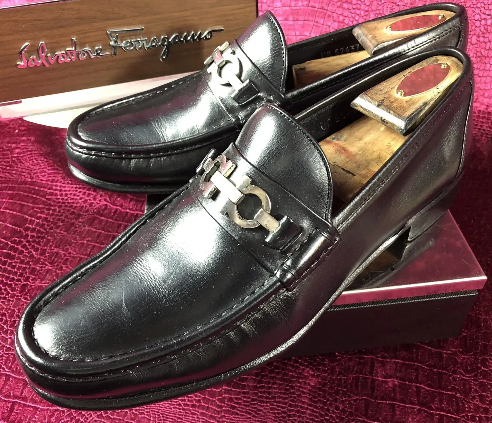 A pair of salvatore ferragamo loafers sitting on top of a box