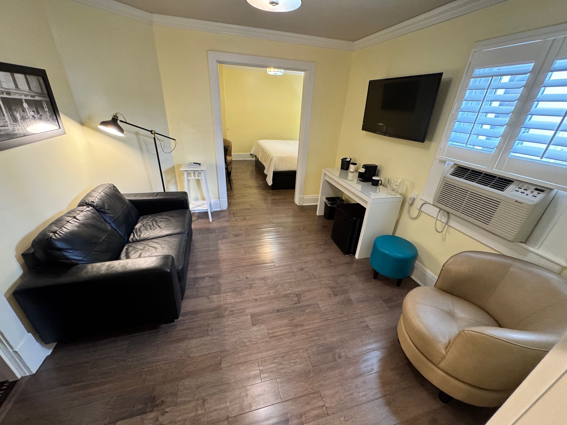 A living room with a couch , chair and television