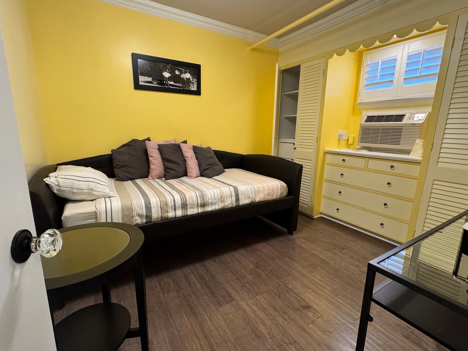 A bedroom with a day bed and a table