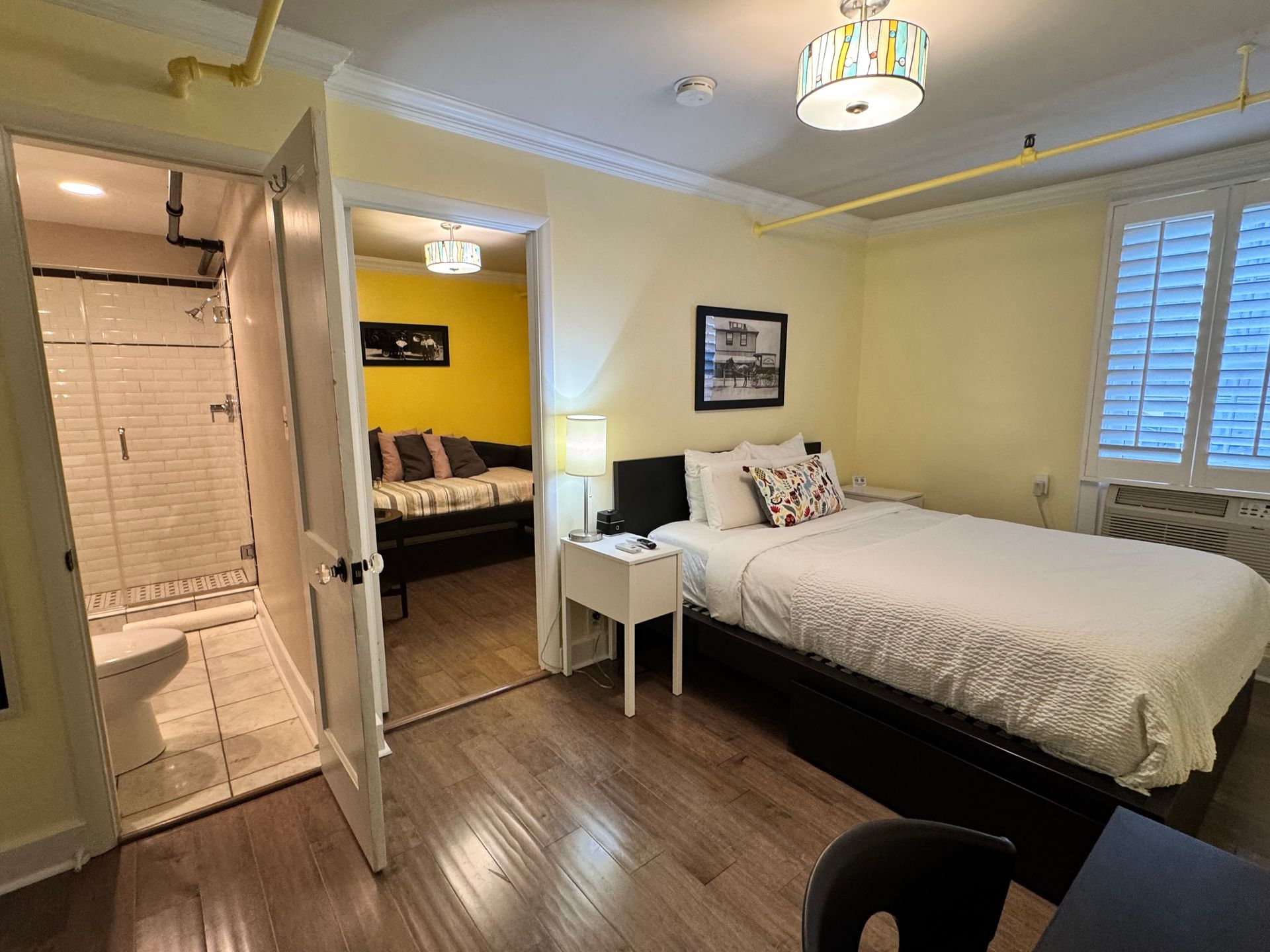 A hotel room with a king size bed and a bathroom.
