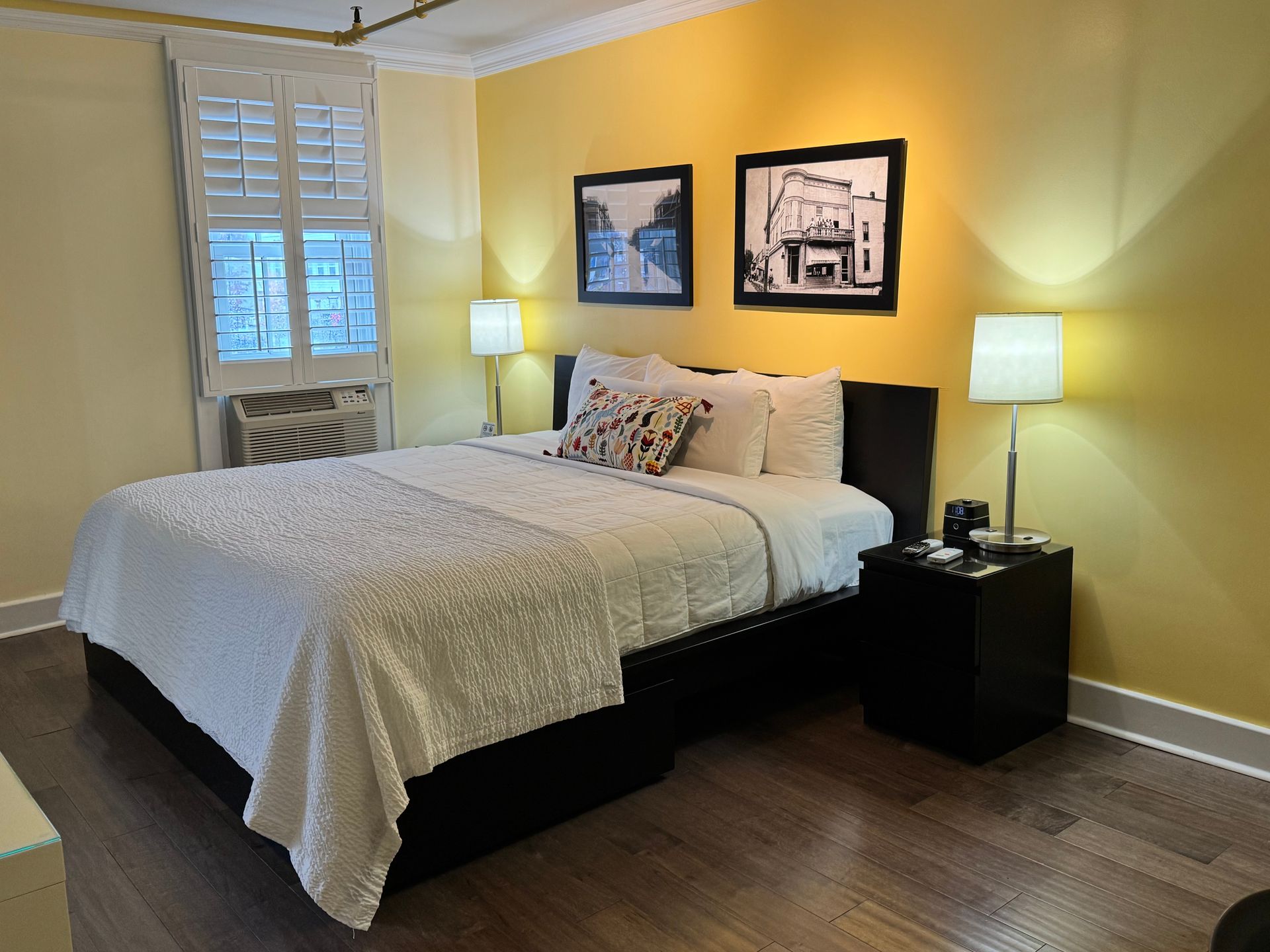 A hotel room with a king size bed and two nightstands