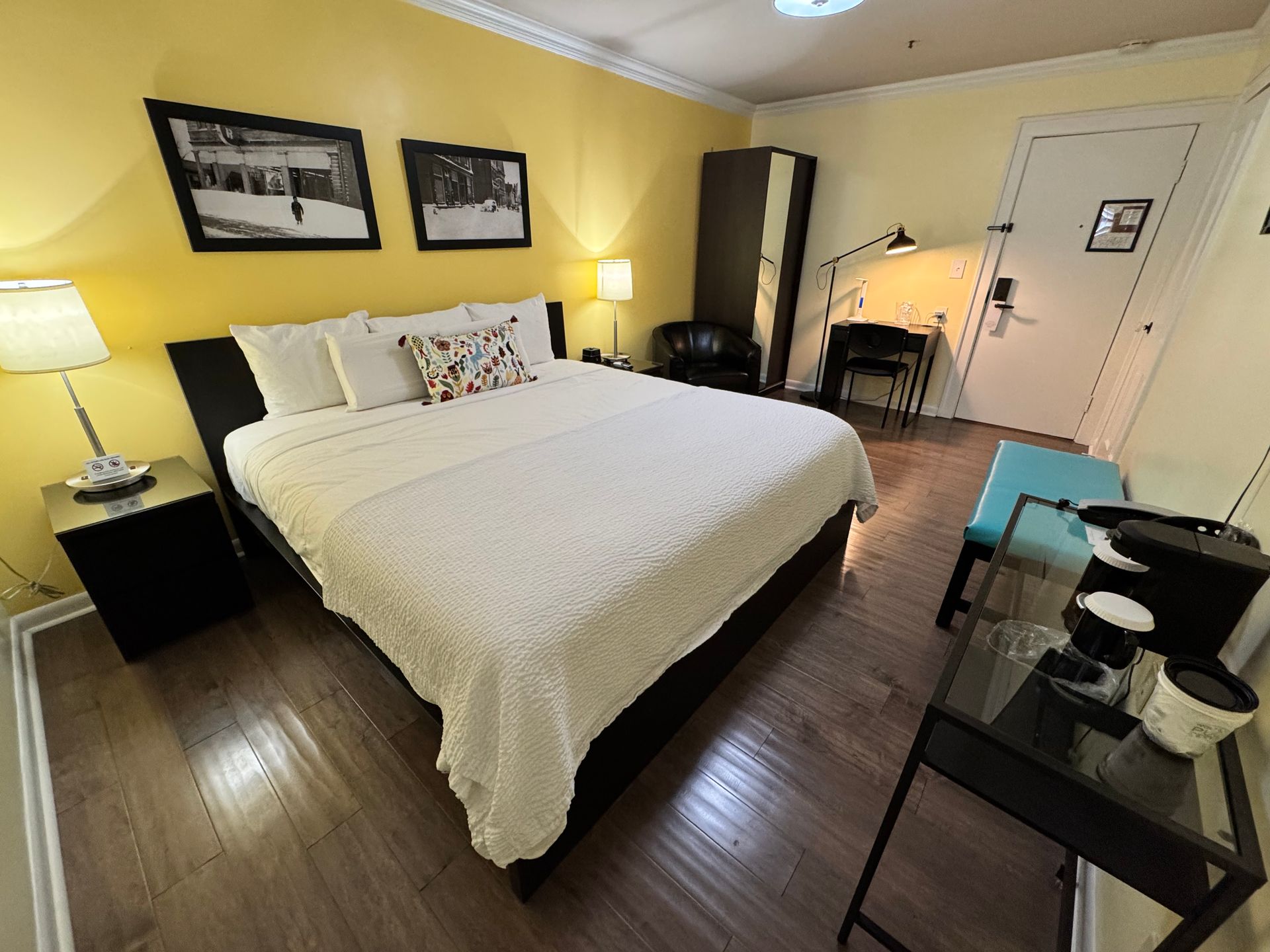 A hotel room with a large bed and a desk