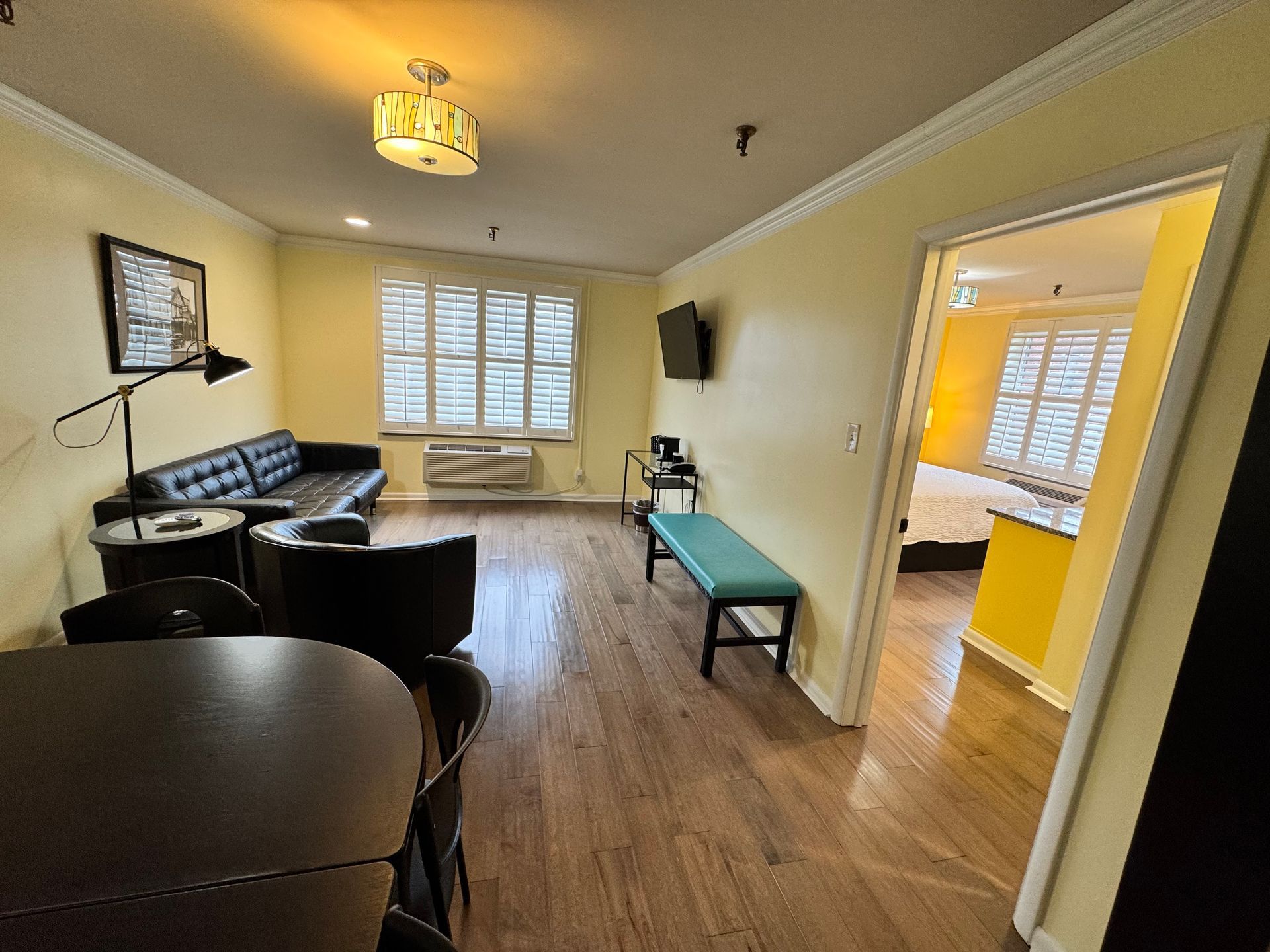 A living room with a couch , table and chairs