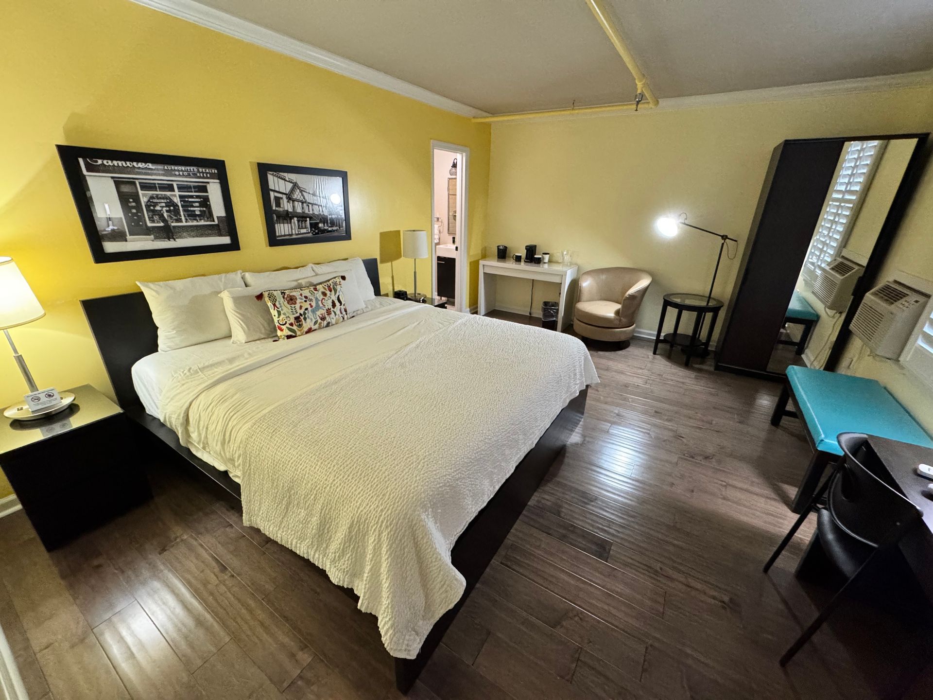 A bedroom with a king size bed and a desk