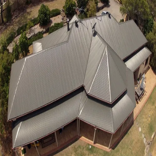 An aerial view of a large house with a metal roof