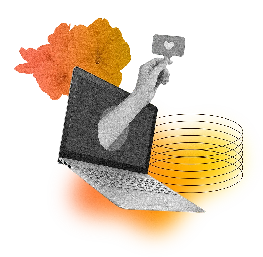 Uma mão está saindo da tela de um laptop segurando uma placa em forma de coração.