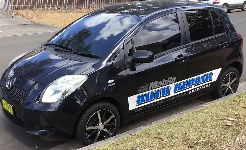 A Black Car is Parked on the Side of the Road — Auto Repair Solutions Unanderra In Unanderra, NSW
