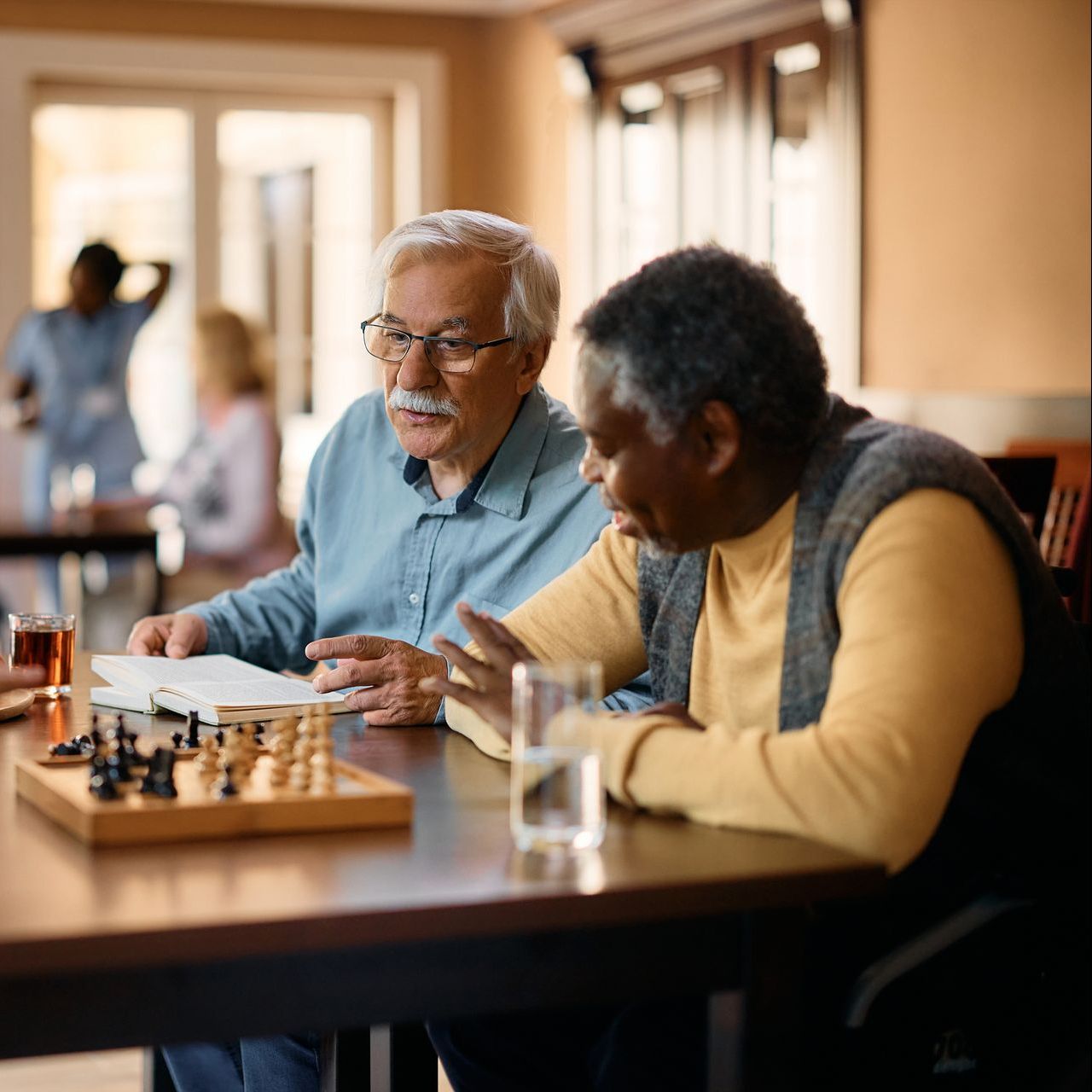 Two men are sitting at a table playing a game of chess